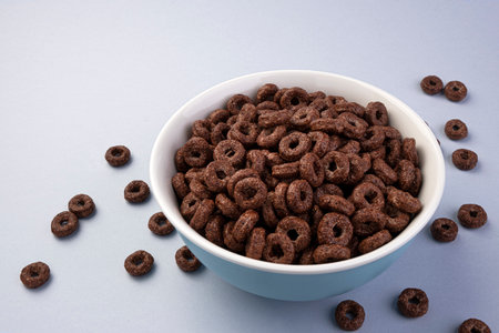 Chocolate corn rings in bowl isolated on white background