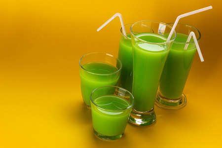 Glass of green juice with copy space for text, fresh apple and celery cocktail, healthy drink conceptの写真素材