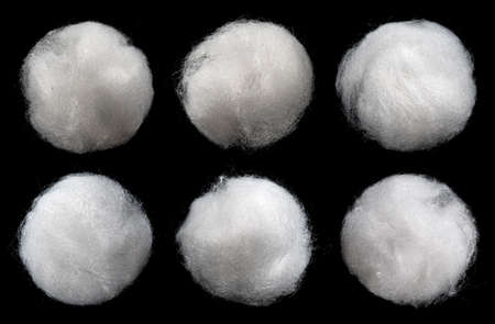 Balls of fluffy cotton wool isolated on black background