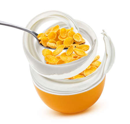 Falling corn flakes with milk splash isolated on white backgroundの写真素材
