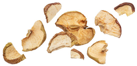 Falling dried apple slices isolated on white background with clipping path, full depth of fieldの写真素材
