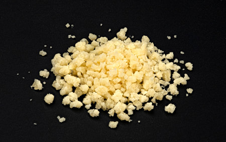 Grated parmesan cheese on black backgroundの写真素材