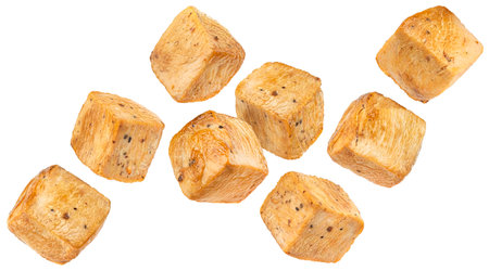 Roasted chicken cubes isolated on white backgroundの写真素材