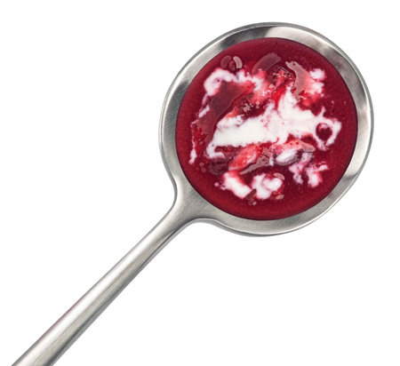 Borscht with sour cream in spoon, beetroot soup isolated on white background, top viewの写真素材