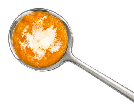 Spoon of Thai cream soup with coconut milk isolated on white background, top viewの写真素材