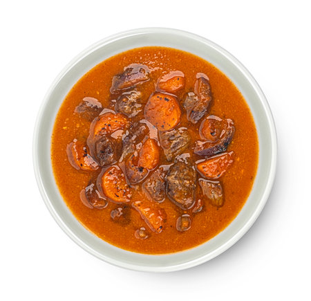 Beef stew with potatoes, carrots and herbs isolated on white background, top viewの写真素材