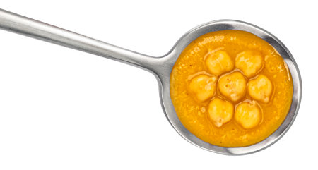 Vegetarian chickpea cream soup in spoon isolated on white background.の写真素材