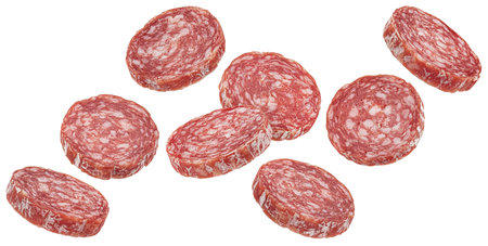 Falling slices of traditional Italian salami sausage isolated on white backgroundの写真素材