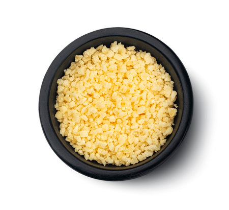 Grated parmesan cheese in black bowl isolated on white background, top viewの写真素材