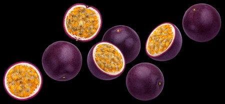 Falling passion fruits isolated on black backgroundの写真素材