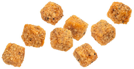 Deep fried breaded tofu cubes isolated on white backgroundの写真素材