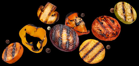 Falling grilled vegetable slices on black backgroundの写真素材