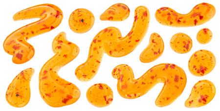 Red hot chili pepper sauce drops, sweet and sour sauce splashes isolated on white background with clipping pathの写真素材