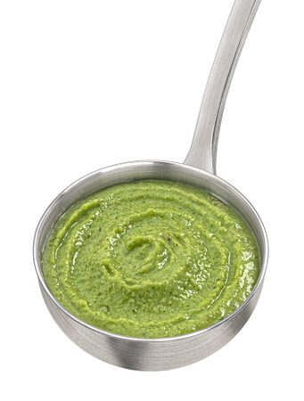 Ladle with broccoli cream soup isolated on white background, full depth of fieldの写真素材