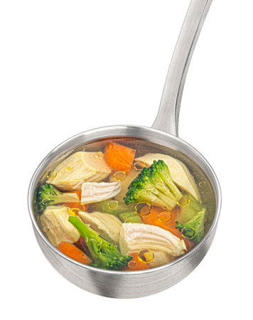 Ladle with chicken soup with vegetables isolated on white background, top view, package design elementの写真素材