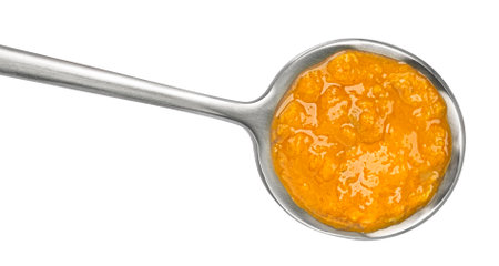 Spicy asian cream soup in spoon isolated on white background, top viewの写真素材