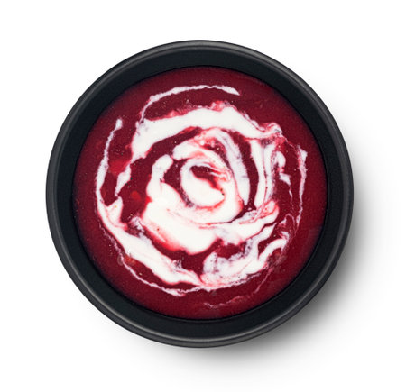 Beetroot soup with sour cream in black bowl isolated on white background, top viewの写真素材