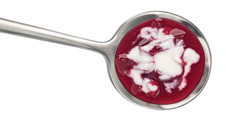 Borscht with sour cream in spoon, beetroot soup isolated on white background, top viewの写真素材