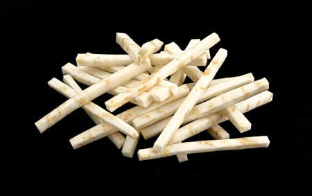Chopped celery root isolated on black backgroundの写真素材