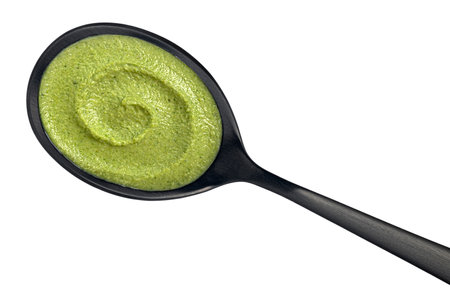 Broccoli cream soup in spoon isolated on white background.の写真素材
