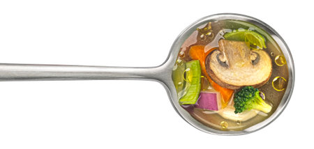 Spoon with mushroom soup, champignon broth isolated on white backgroundの写真素材