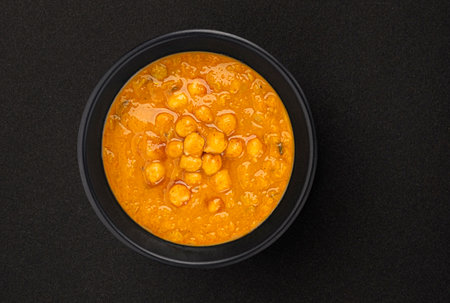 Vegetarian chickpea cream soup on black backgroundの写真素材