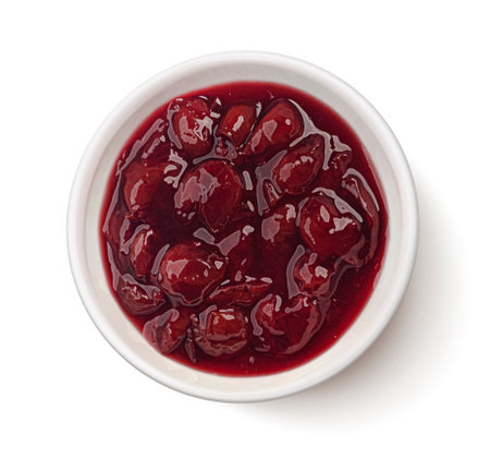 Homemade cherry jam with whole berries isolated on white background, top viewの写真素材