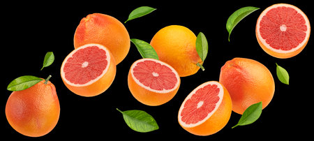 Falling grapefruits isolated on black background, package design elementの写真素材