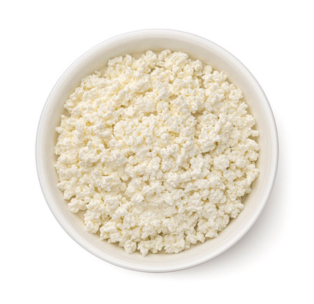 Bowl of cottage cheese isolated on white background, top view, flat layの写真素材
