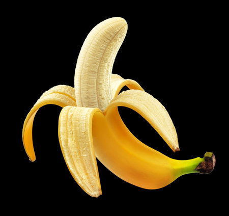 Half peeled banana isolated on black background, package design elementの写真素材