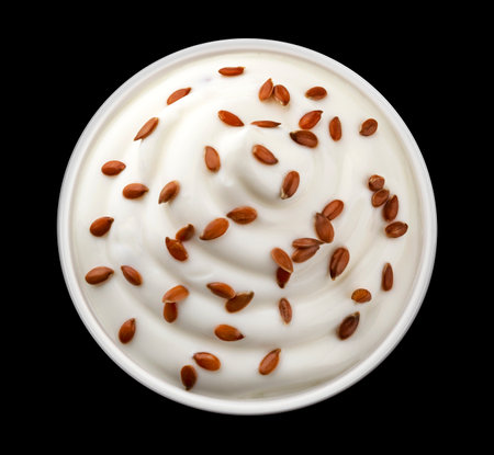 Bowl of yogurt with flax seeds isolated on black background, top viewの写真素材