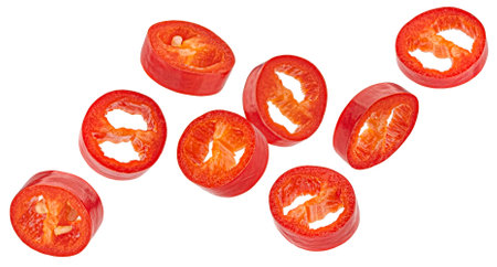 Falling red chili pepper slices isolated on white background with clipping path, package design elementの写真素材