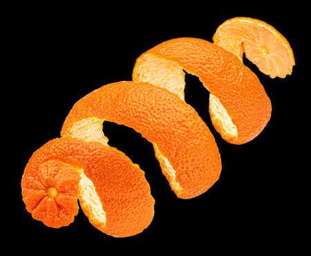 Twisted orange peel isolated on black background, package design element, full depth of fieldの写真素材