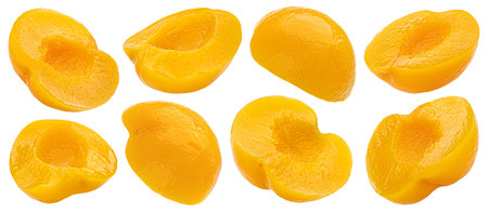 Canned peach or apricot fruit halves isolated on white backgroundの写真素材