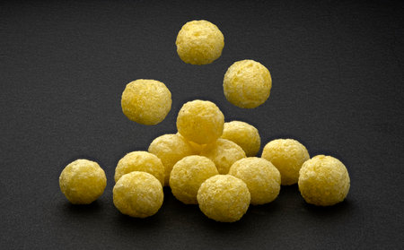 Falling corn balls isolated on black background with copy space, full depth of fieldの写真素材