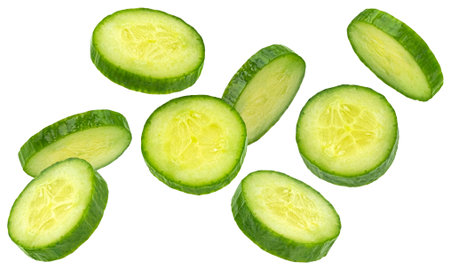 Falling cucumber slices isolated on white background with clipping path, full depth of fieldの写真素材