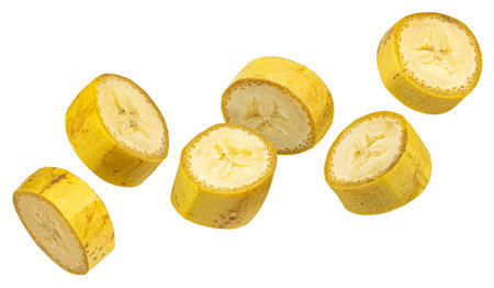 Falling banana slices isolated on white background with clipping path, full depth of fieldの写真素材