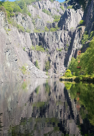 fjord landscape with mountains, forests and water reflectionsの写真素材