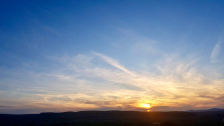 Beautiful sunset in the blue sky with clouds. Nature background.の写真素材