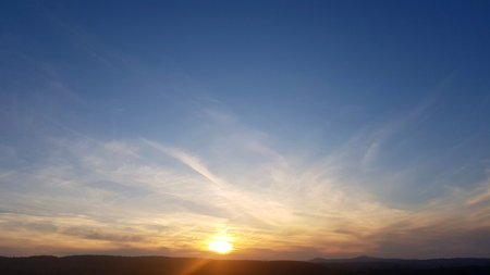 Beautiful sunset sky with clouds. Nature background. Sky with clouds and sun.の写真素材