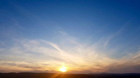 Beautiful sunset sky with clouds. Nature background. Sky with clouds and sun.の写真素材