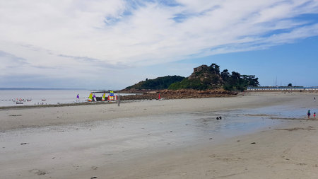 A view of the beach at low tide in Brittany, France.の写真素材