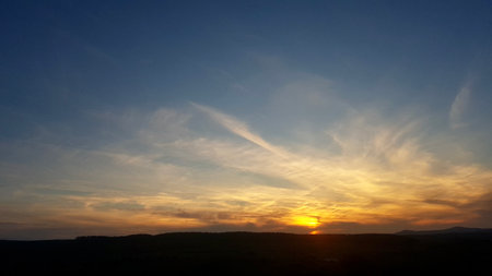Sunset in the mountains. Beautiful sky with clouds at sunset.の写真素材