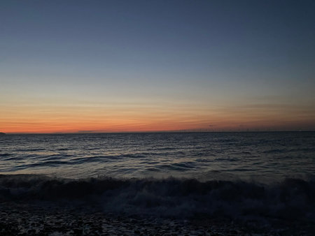 Beautiful sunset on the sea. The sky is orange and blue.の写真素材