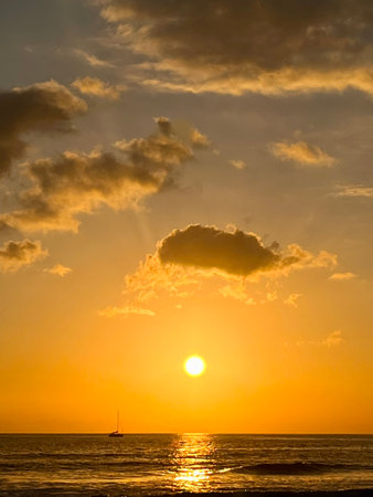 Beautiful sunset over the sea. Colorful dramatic sky, cloudscape. The sun sets turning the sky yellow and orange.の写真素材