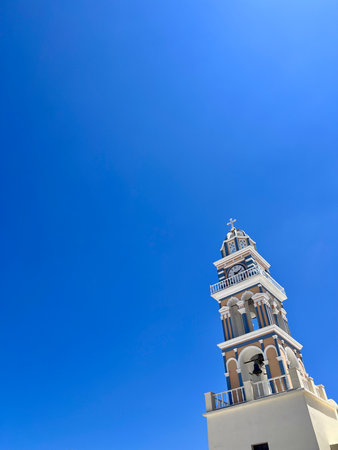 Tower of the church against the blue sky in Santorini, Greeceの写真素材