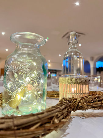 wedding table decoration with candles and glass vase, stock photoの写真素材
