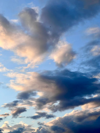 Clouds in the blue sky at sunset as an abstract background.の写真素材