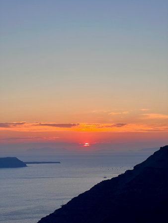 Sunset over the Aegean Sea in Santorini, Greeceの写真素材