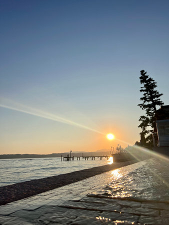 Sunset on the beach with wooden pier and tree, Thailand.の写真素材